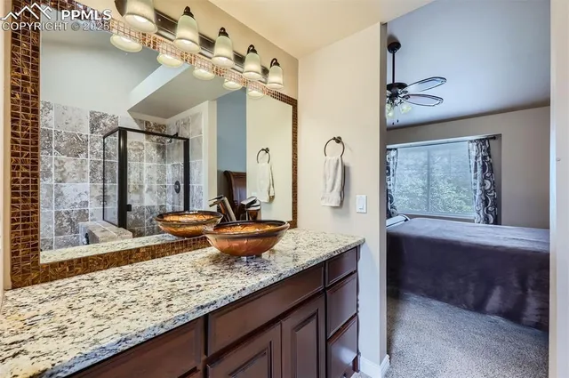 a bathroom with a granite countertop sink a large mirror and a bathtub