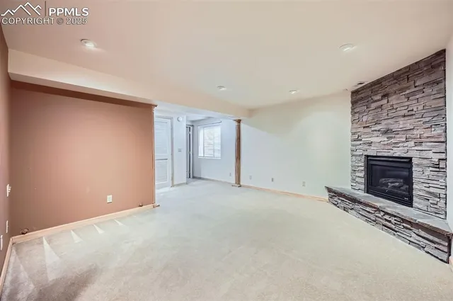 a view of an empty room with a fireplace