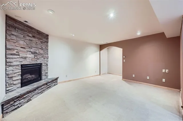 a view of empty room with a fireplace