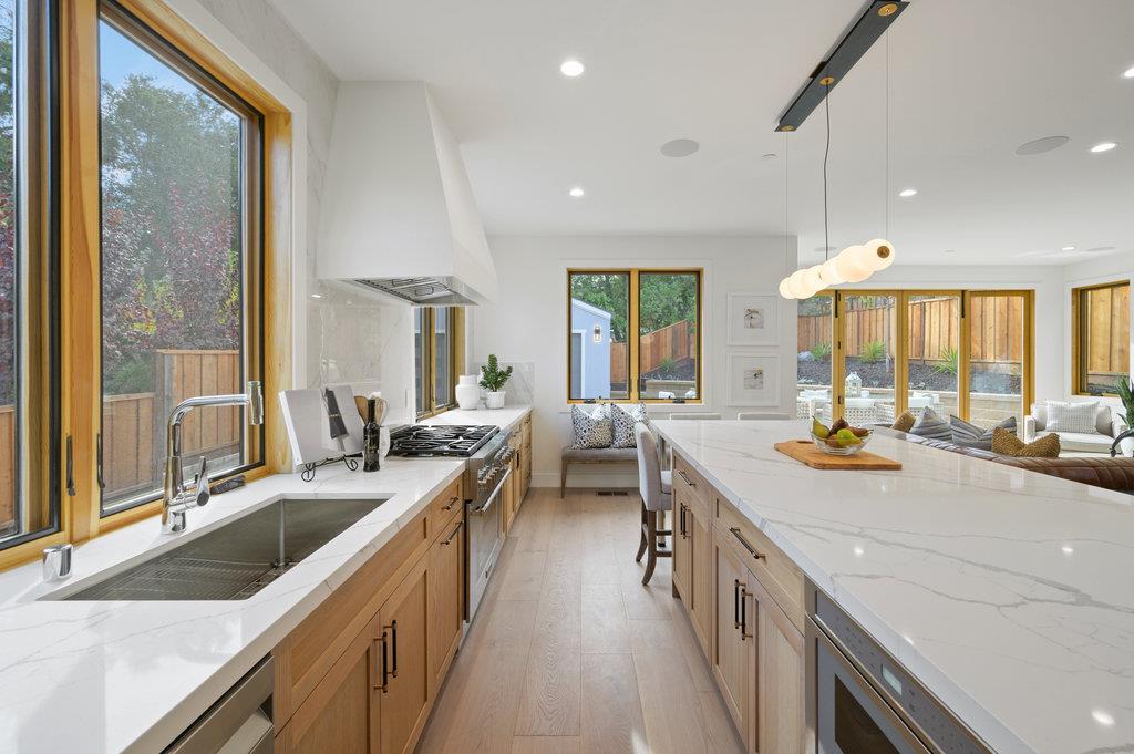 1327 Benito Avenue Burlingame, CA 94010 - Photo 12 of 41 a kitchen with a sink stove and wooden cabinets