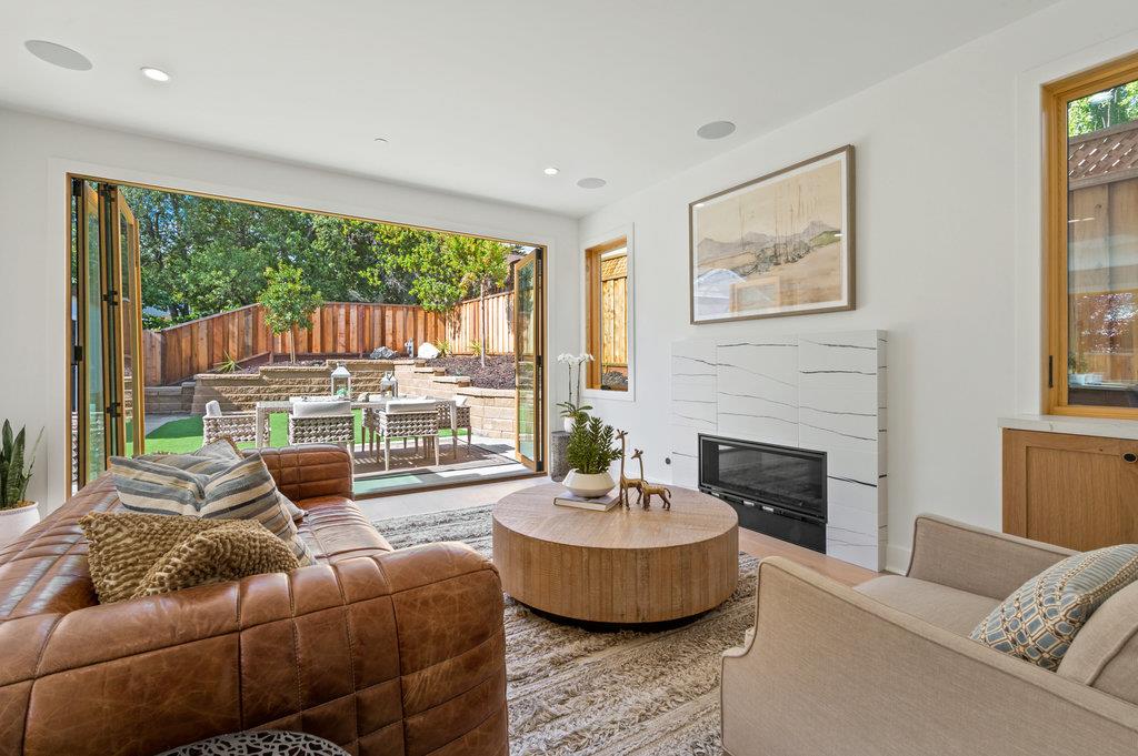 1327 Benito Avenue Burlingame, CA 94010 - Photo 16 of 41 a living room with furniture fireplace and a large window