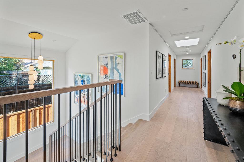 1327 Benito Avenue Burlingame, CA 94010 - Photo 30 of 41 a view of a hallway with windows and chandelier