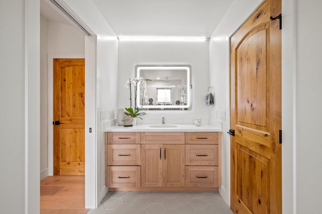 1327 Benito Avenue Burlingame, CA 94010 - Photo 33 of 41 a spacious bathroom with a granite countertop sink mirror and a bathtub