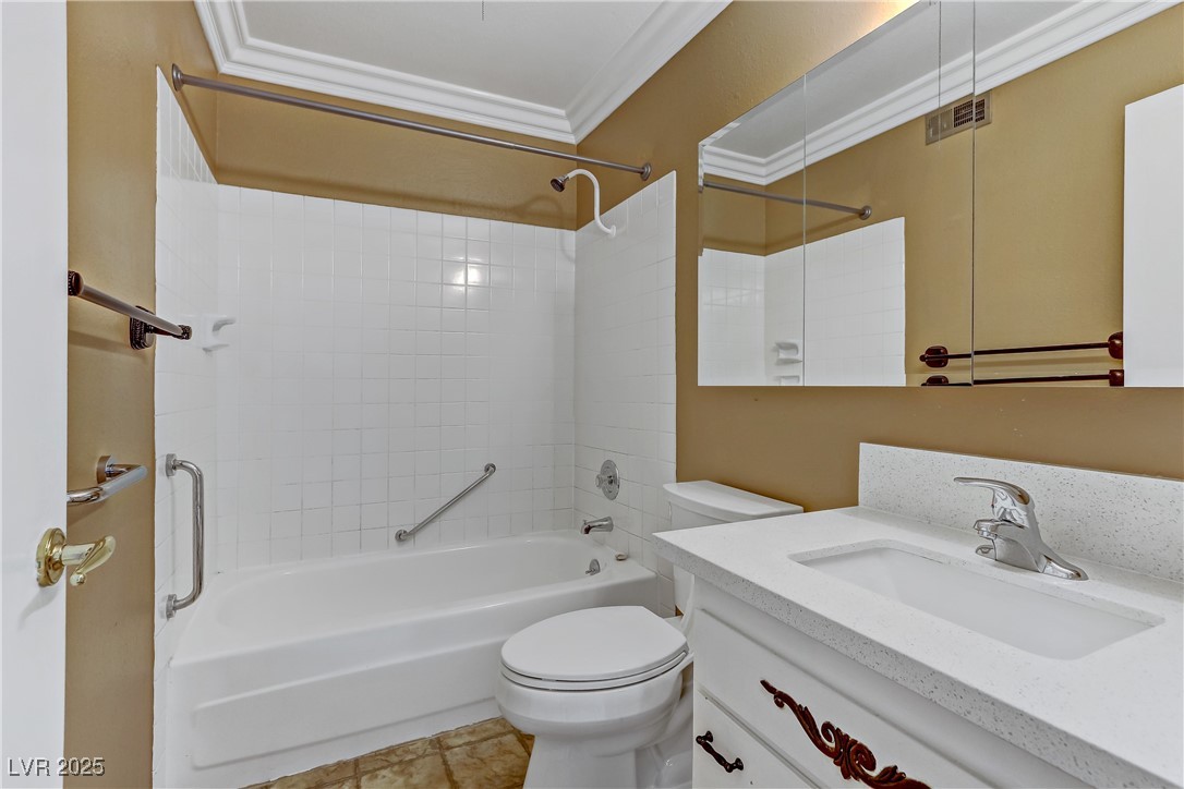 7301 Pleasant View Avenue Las Vegas, NV 89147 - Photo 21 of 37 Full bath featuring shower combination, vanity, ornamental molding, and light tile patterned floors