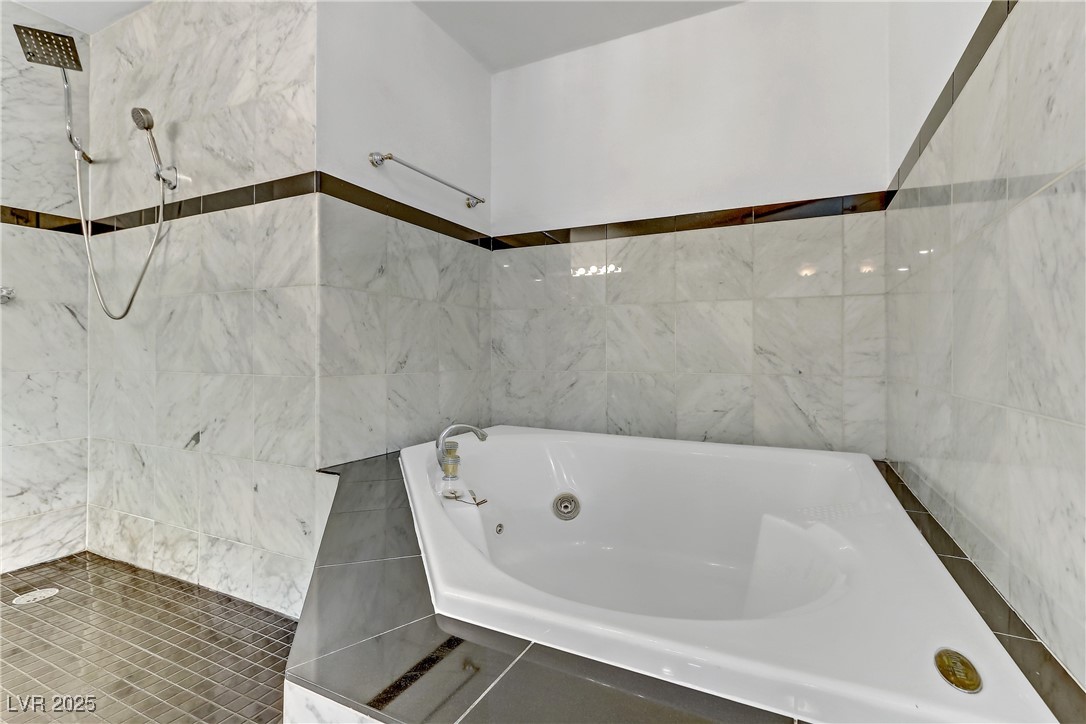 7301 Pleasant View Avenue Las Vegas, NV 89147 - Photo 30 of 37 Full bath with tile walls, a tub with jets, and tiled shower