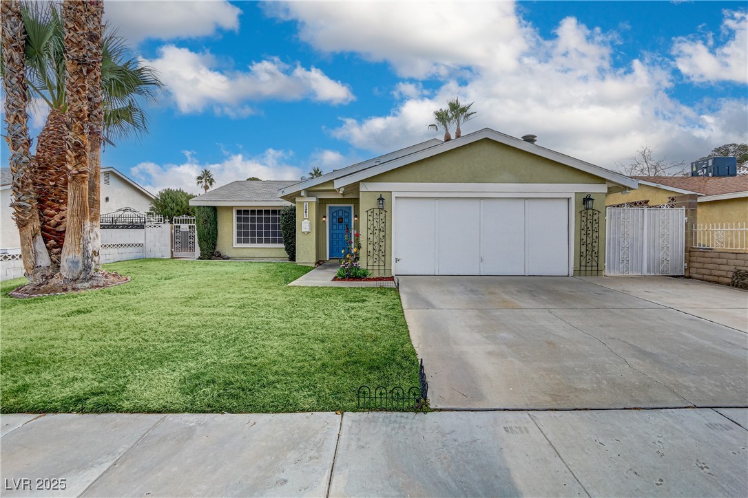 7301 Pleasant View Avenue Las Vegas, NV 89147 - Photo 3 of 37 Ranch-style house featuring stucco siding, driveway, a gate, and a garage