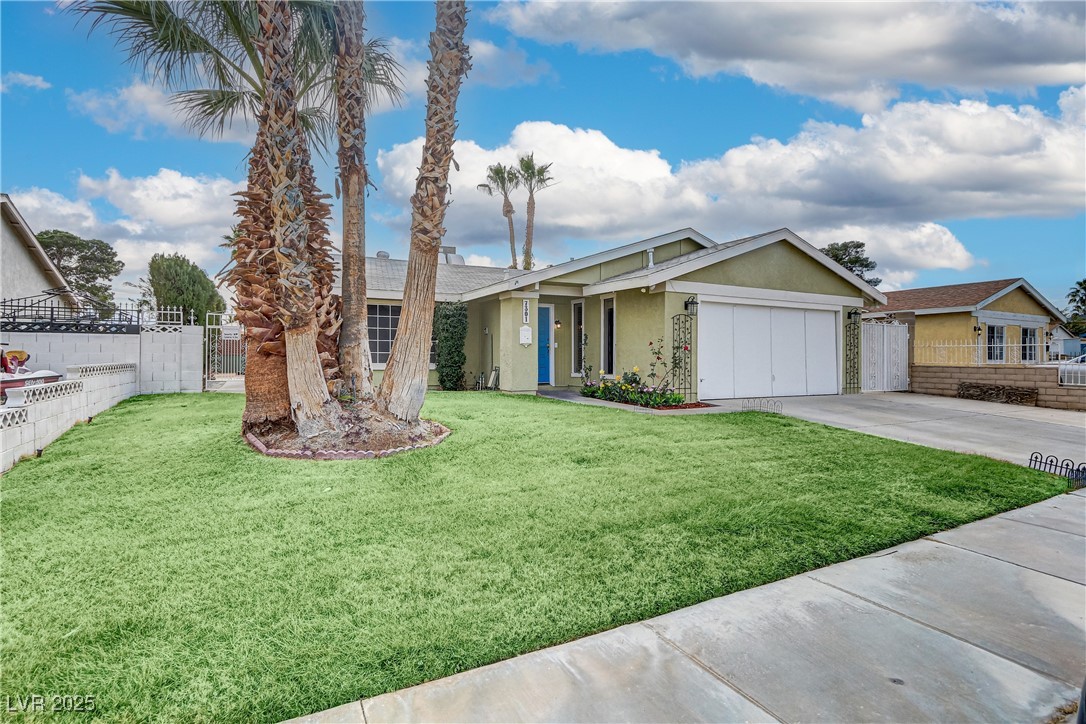 7301 Pleasant View Avenue Las Vegas, NV 89147 - Photo 4 of 37 Ranch-style house with stucco siding, driveway, and an attached garage