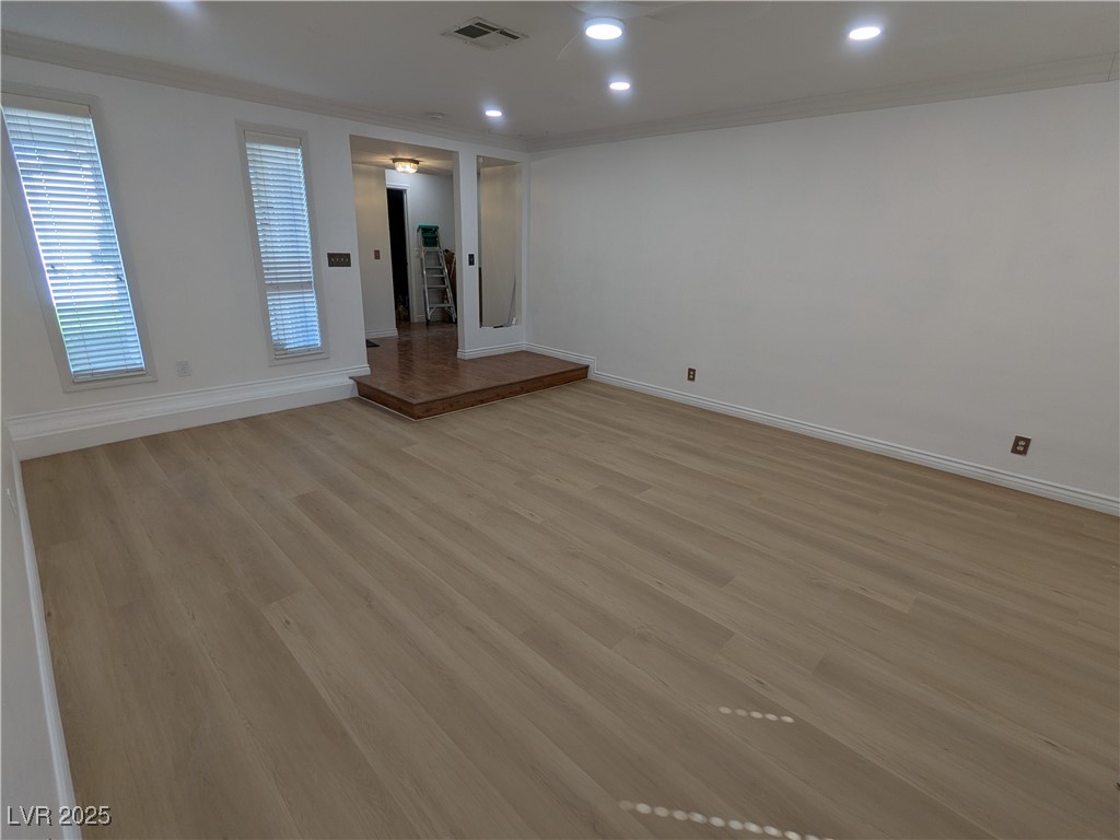 7301 Pleasant View Avenue Las Vegas, NV 89147 - Photo 8 of 37 Empty room featuring light wood-type flooring, ornamental molding, and recessed lighting