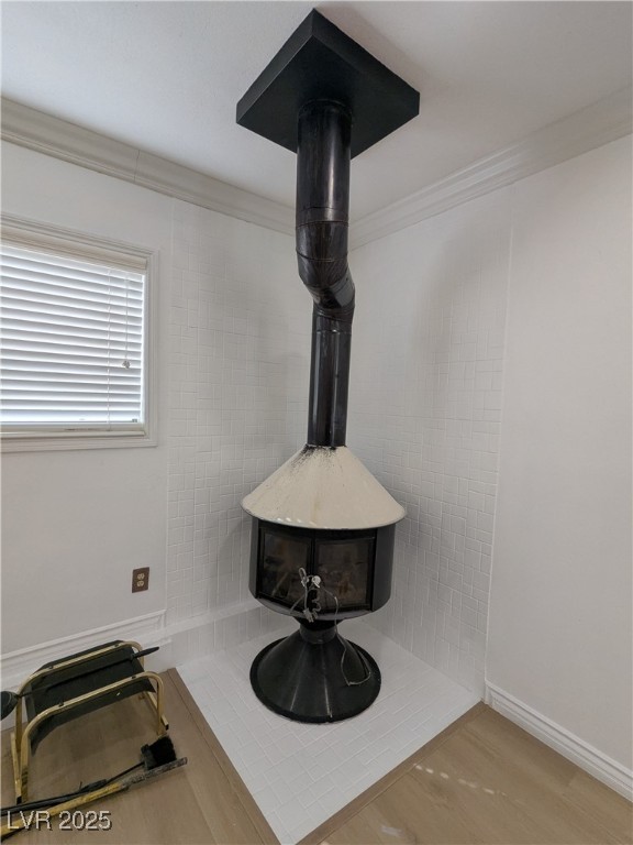 7301 Pleasant View Avenue Las Vegas, NV 89147 - Photo 9 of 37 Detailed view of a wood stove, wood finished floors, and crown molding