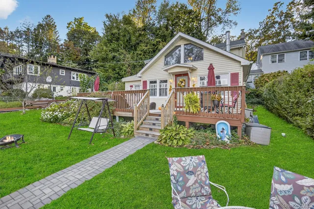 a front view of a house with a yard table and chairs