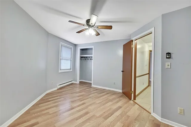 a view of a livingroom with a ceiling fan and window