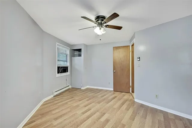 a view of a livingroom with a ceiling fan and window