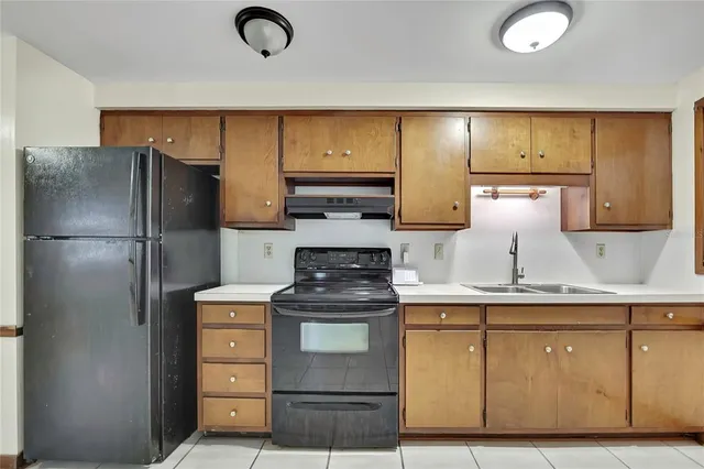 a kitchen with a refrigerator and a stove