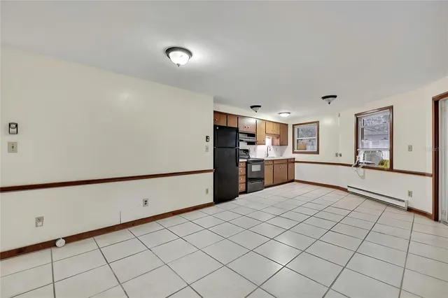a view of kitchen with refrigerator and window