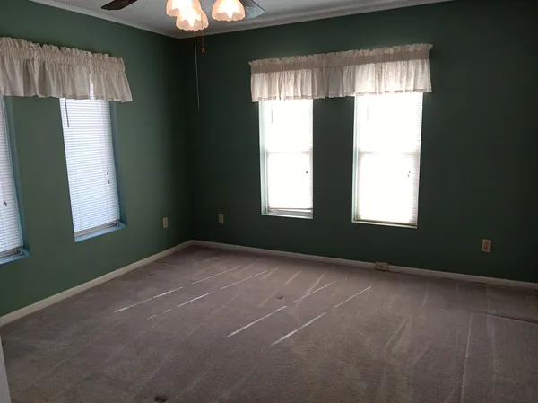 a living room with stainless steel appliances kitchen island granite countertop furniture and a large window