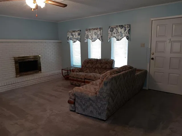 a living room with furniture and a mirror