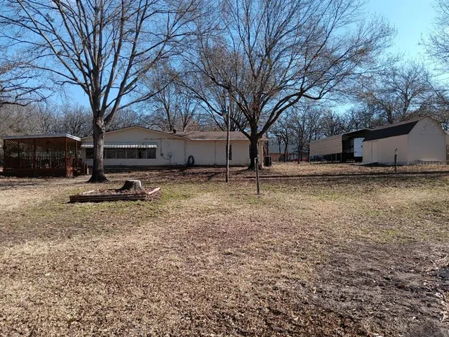 a backyard of a house with trees and houses