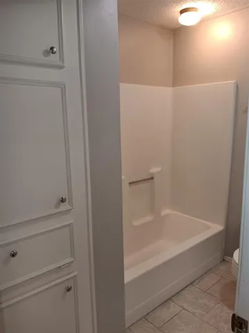 a bathroom with a granite countertop toilet and a sink