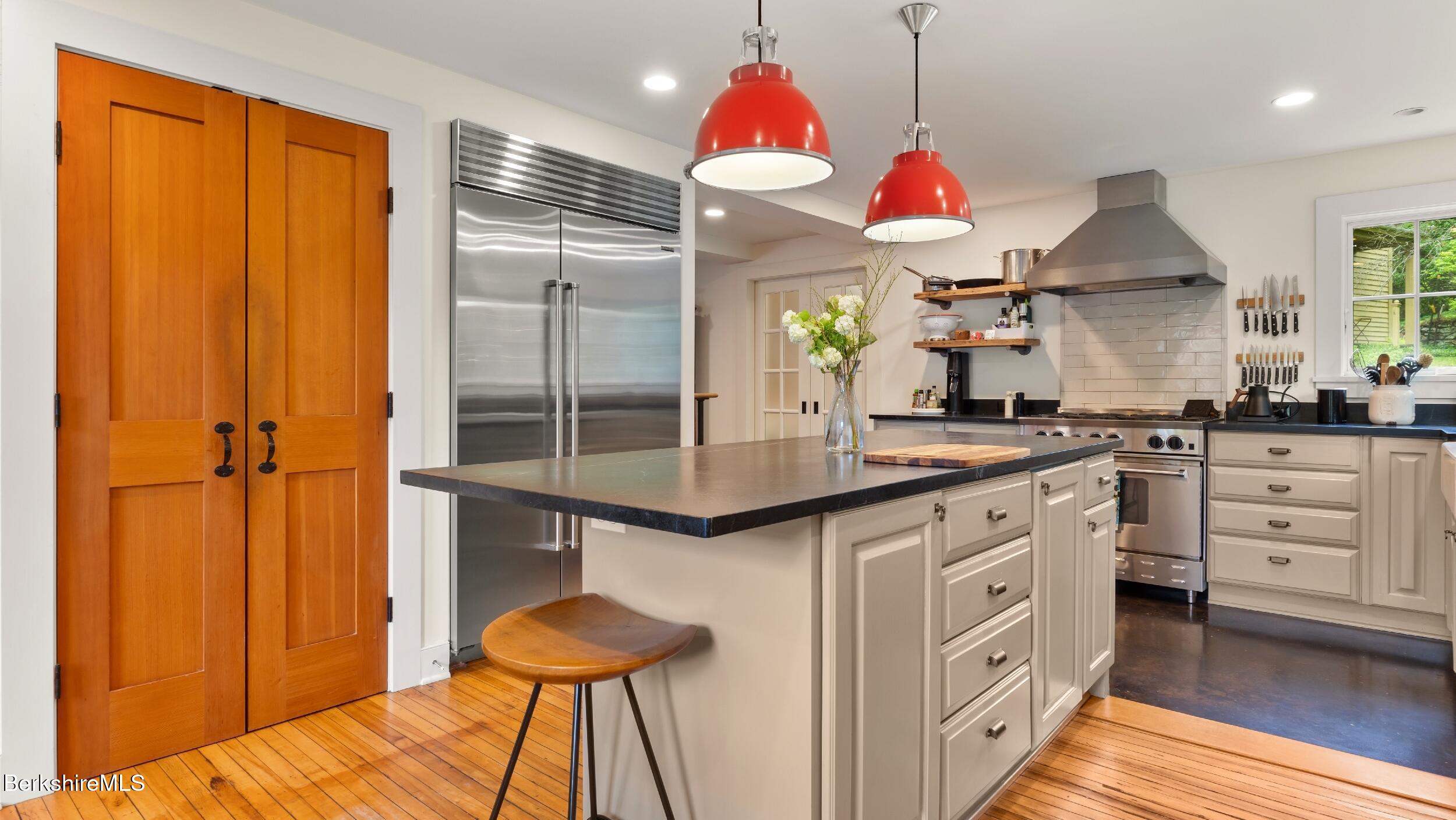 8 Yale Hill Road Stockbridge, MA 01262 - Photo 13 of 51 a kitchen with white cabinets and chandelier