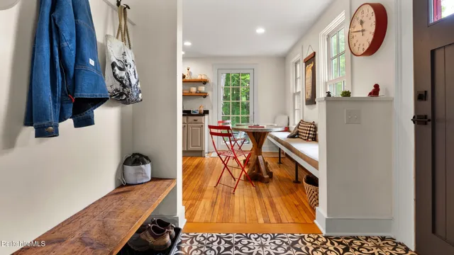 a dining room with furniture a chandelier and wooden floor