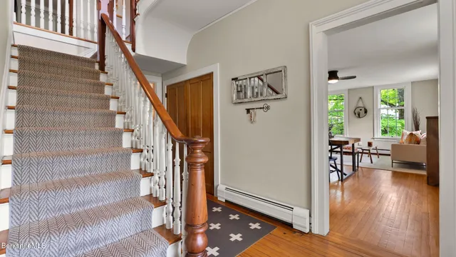 a bathroom with a granite countertop sink a mirror and shower