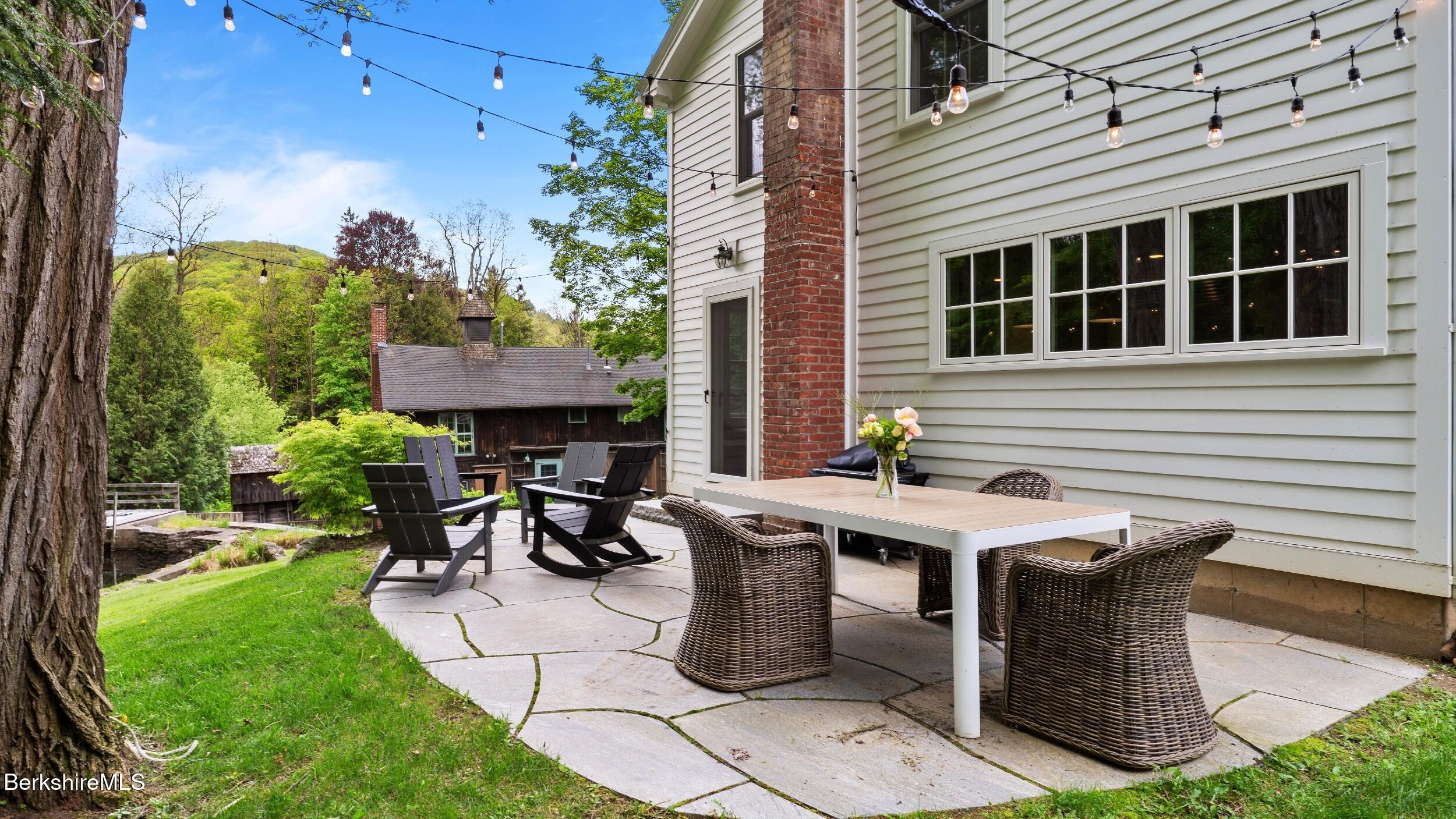 8 Yale Hill Road Stockbridge, MA 01262 - Photo 43 of 51 a view of a patio with table and chairs with plants and garden