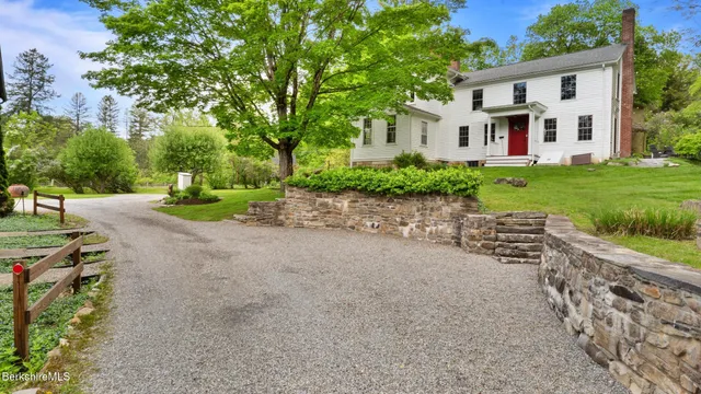 a front view of a house with a yard and trees