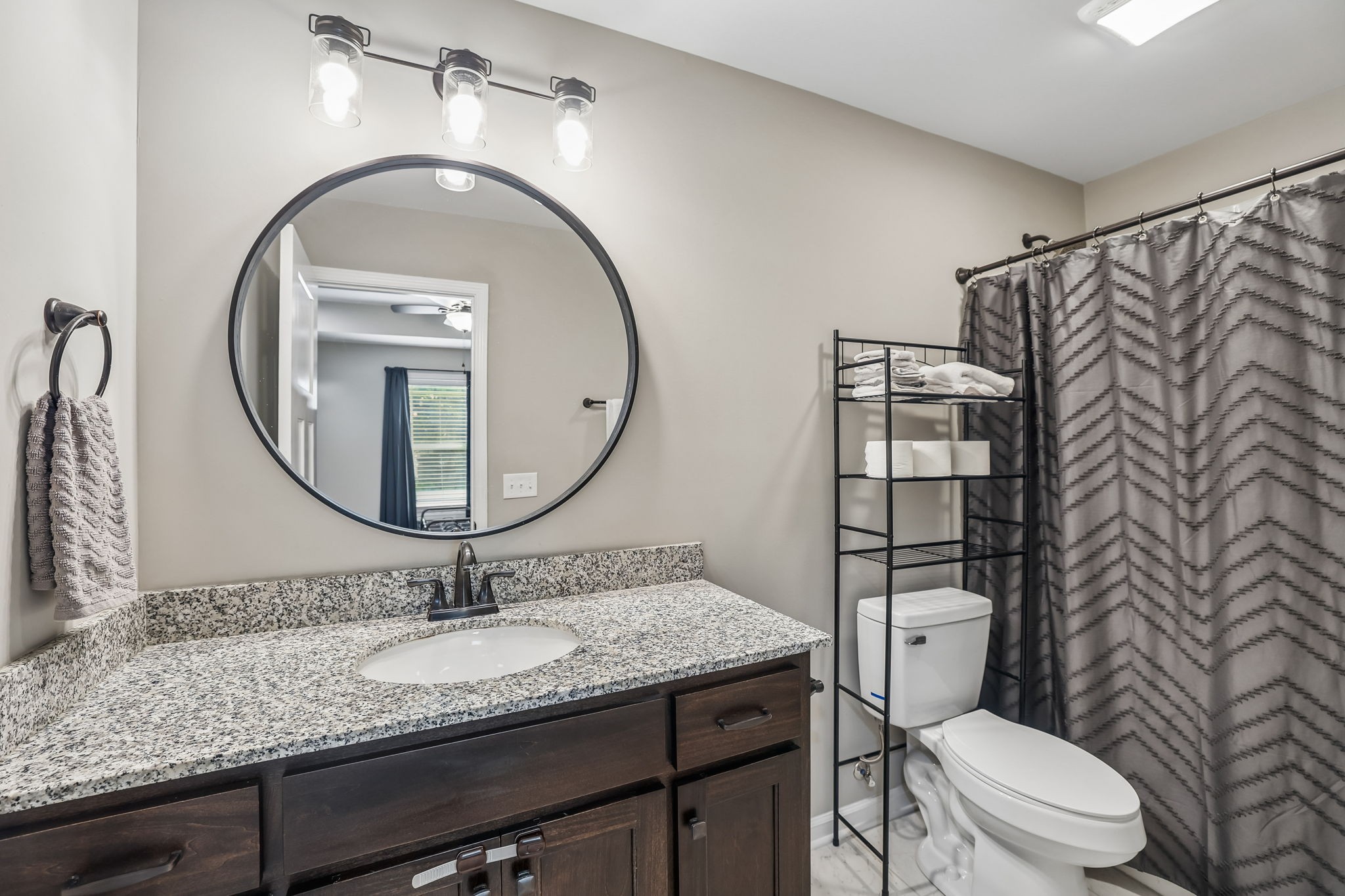1546 South Spring Street Manchester, TN 37355 - Photo 29 of 53 a bathroom with a granite countertop toilet a sink and a mirror