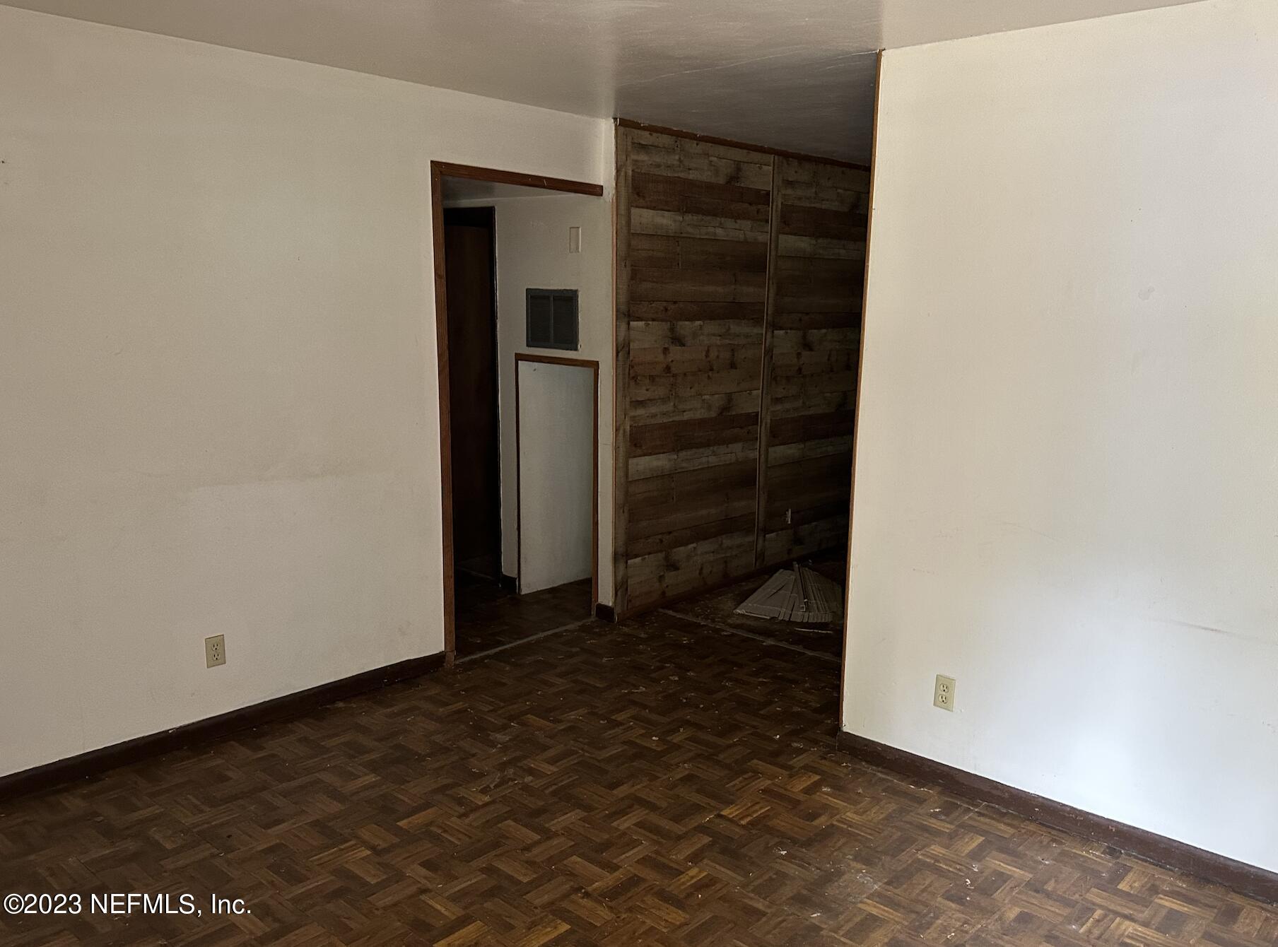7472 Melvin Road Jacksonville, FL 32210 - Photo 5 of 5 an empty room with a door