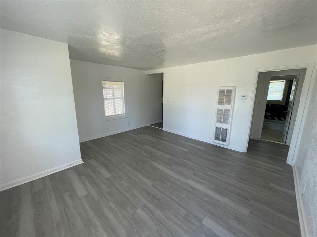 2011 Gilbert Avenue Wichita Falls, TX 76301 - Photo 2 of 7 an empty room with wooden floor and windows