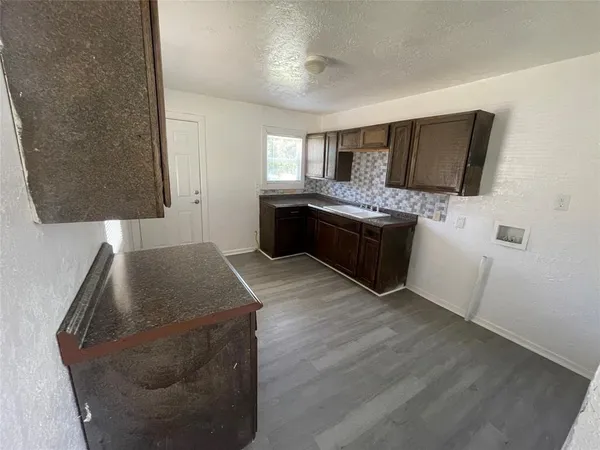 a kitchen with stainless steel appliances granite countertop a stove and a refrigerator