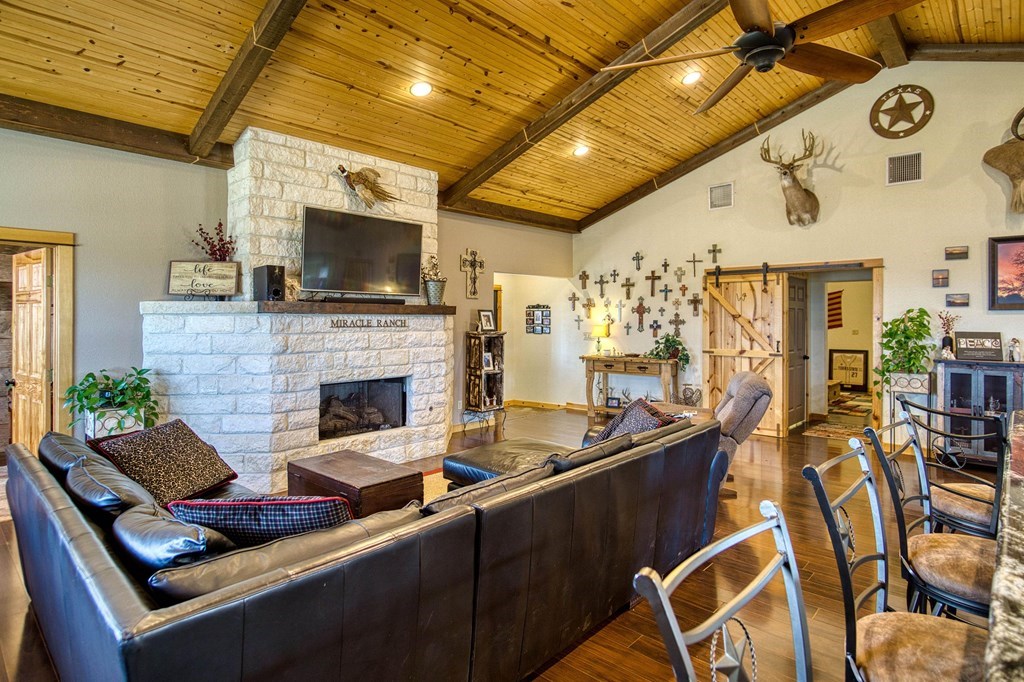 6446 Blackjack Road Fredonia, TX 76842 - Photo 11 of 48 a living room with fireplace furniture and a flat screen tv