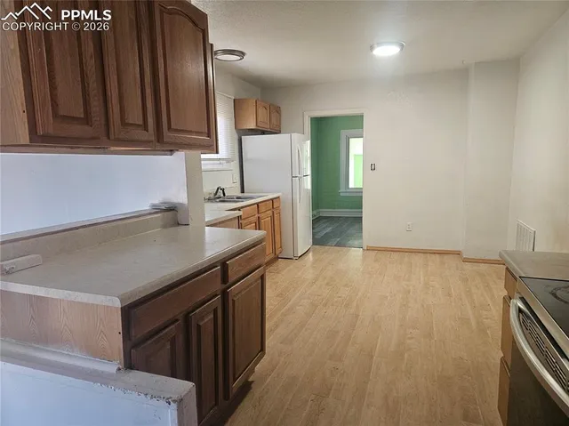 an empty room with wooden floor