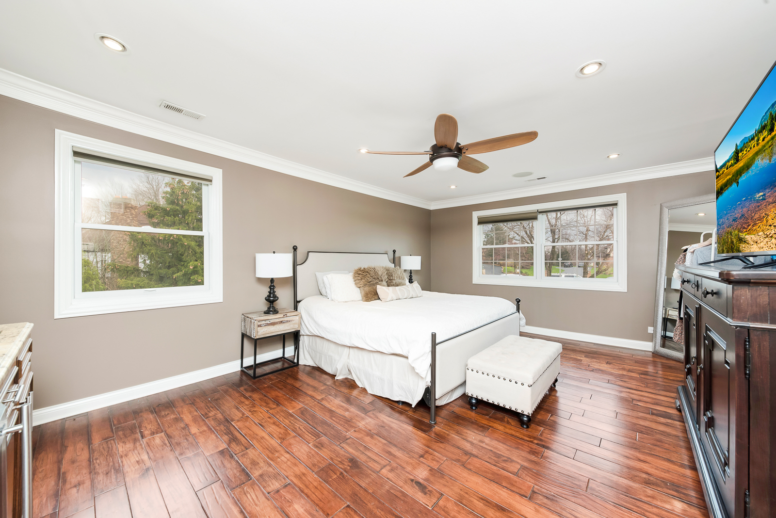 7 Sorrel Lemont, IL 60439 - Photo 23 of 36 a bedroom with a bed and a large window with wooden floor
