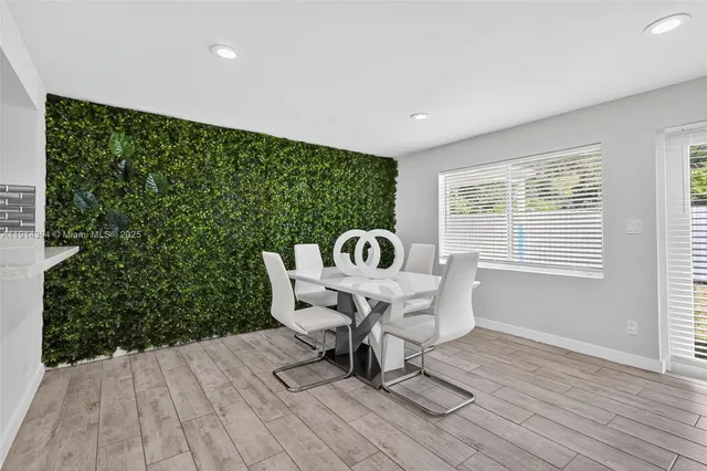 a white table sitting in a room next to a window
