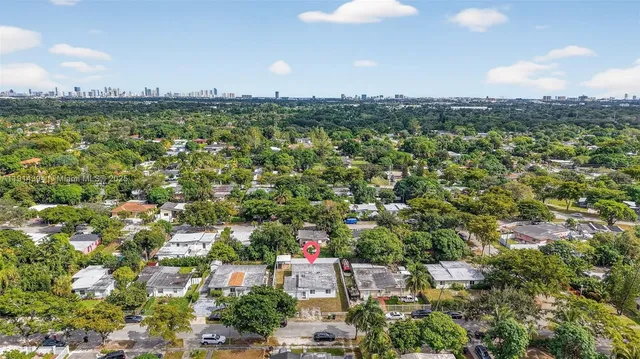 a house that has a tree in front of it