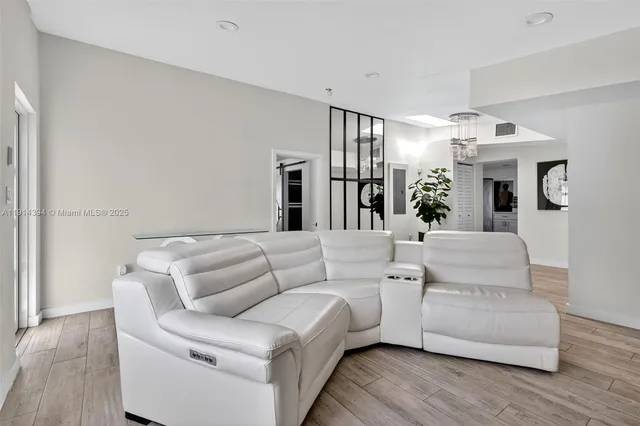 a living room with furniture and a chandelier