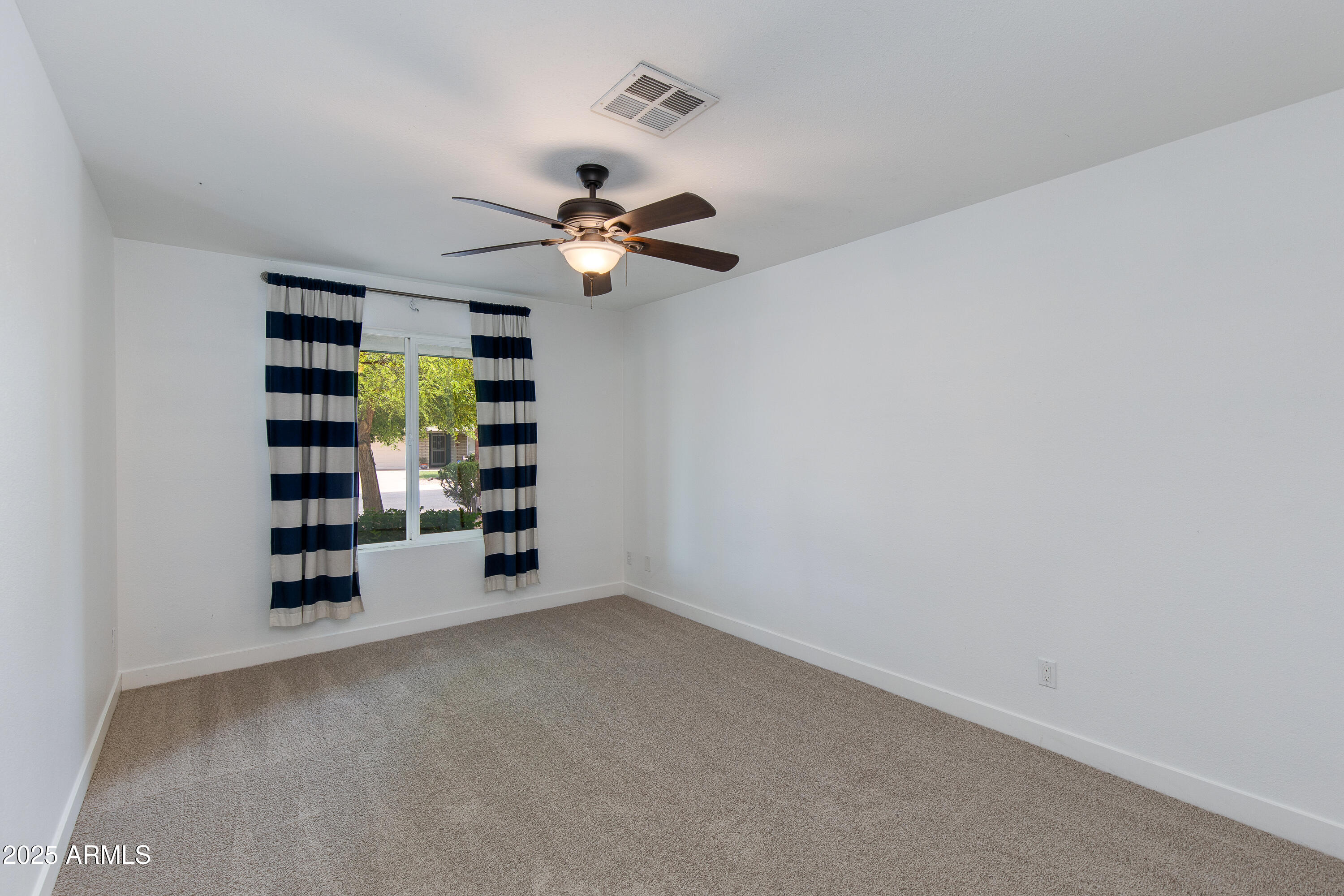 1820 West Seldon Way Phoenix, AZ 85021 - Photo 18 of 29 an empty room with windows and ceiling fan