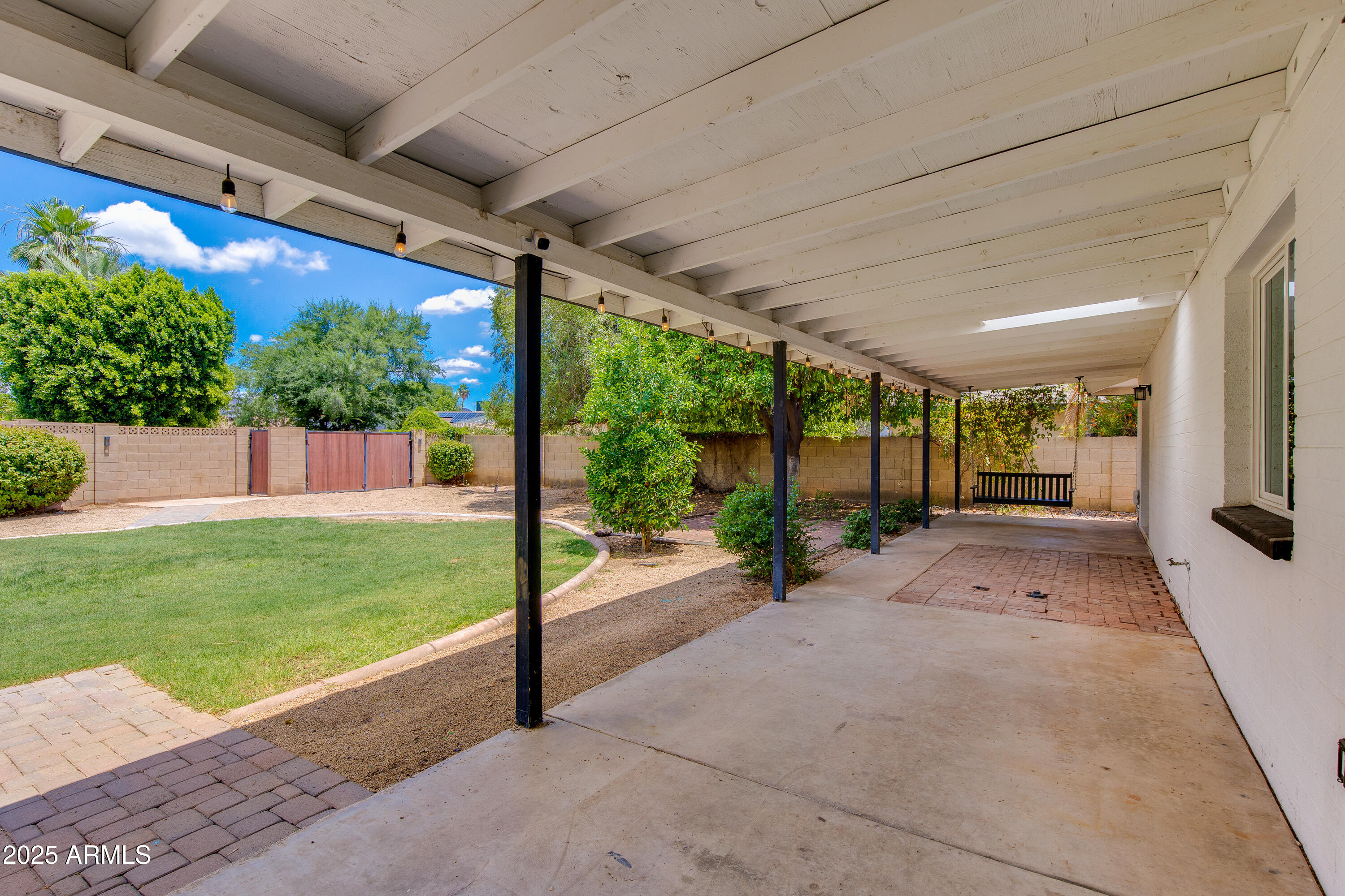 1820 West Seldon Way Phoenix, AZ 85021 - Photo 21 of 29 a view of a patio with table and chairs under an umbrella with a small yard