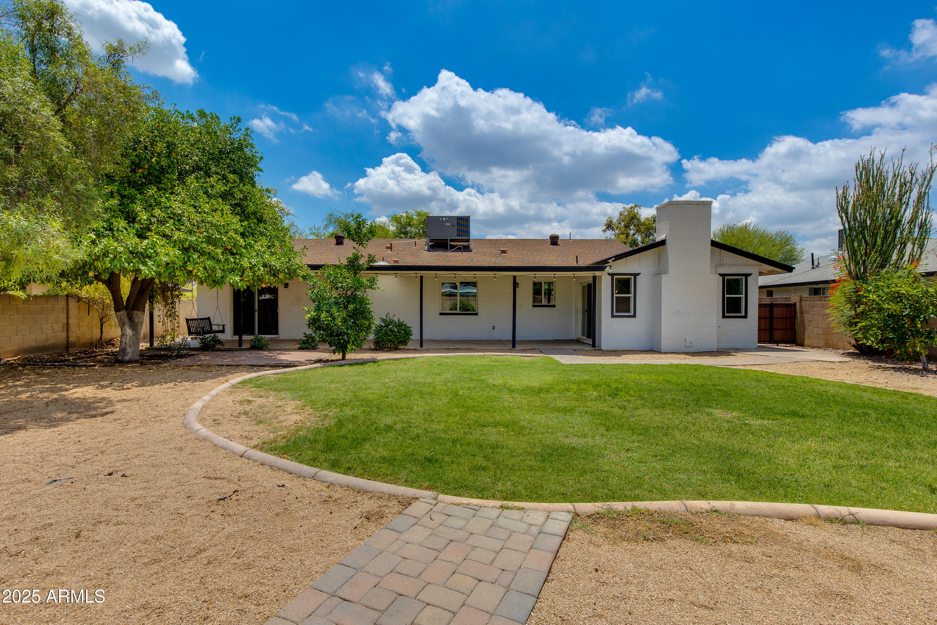 1820 West Seldon Way Phoenix, AZ 85021 - Photo 23 of 29 a view of a white house with a swimming pool and a yard