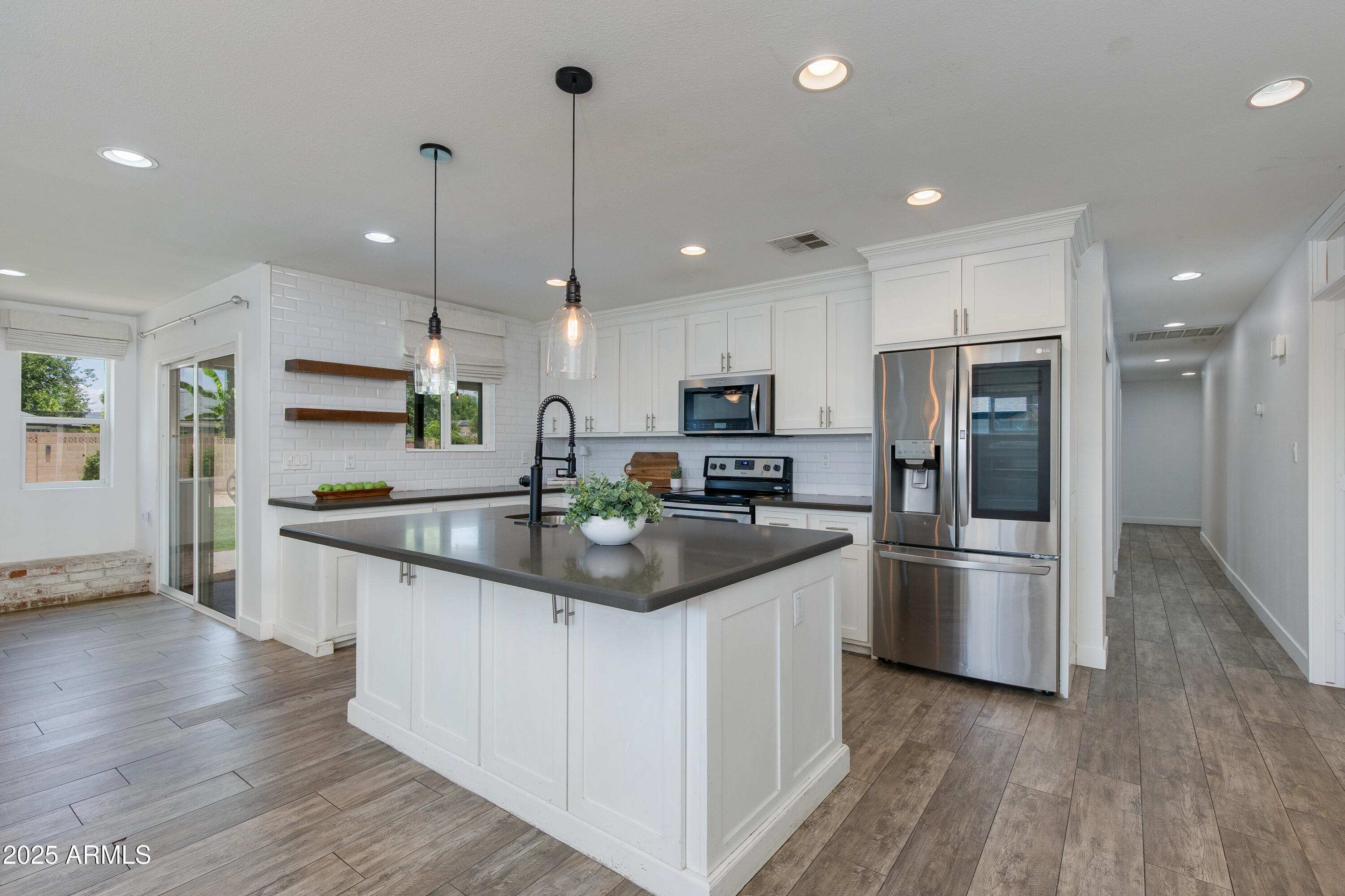 1820 West Seldon Way Phoenix, AZ 85021 - Photo 6 of 29 a kitchen with stainless steel appliances granite countertop a refrigerator a sink and a stove
