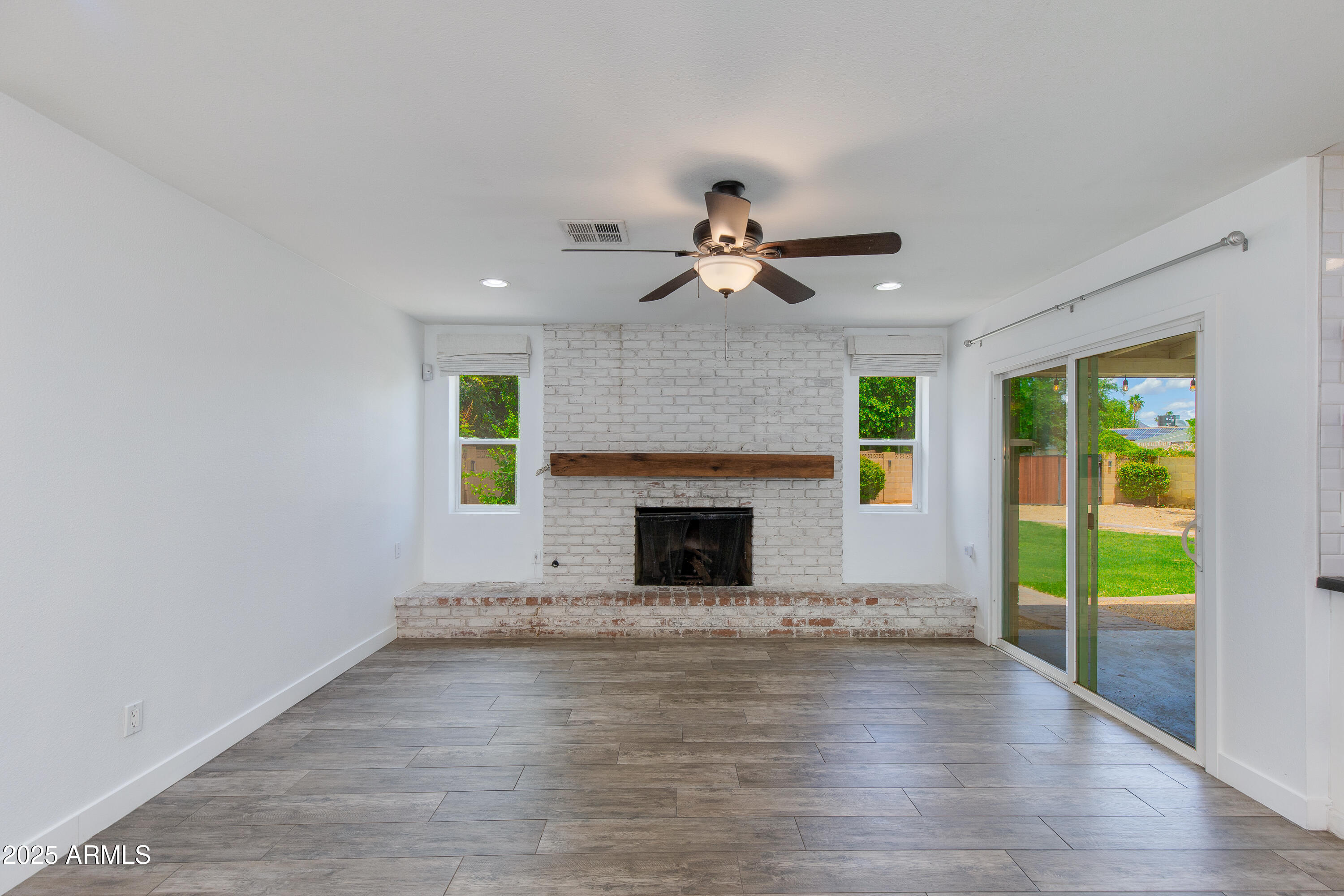 1820 West Seldon Way Phoenix, AZ 85021 - Photo 9 of 29 a view of a livingroom with a fireplace a ceiling fan and a fireplace