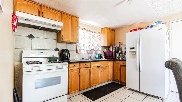 a kitchen with stainless steel appliances a stove a refrigerator and cabinets