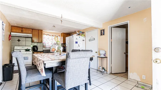 a kitchen with stainless steel appliances a table and chairs