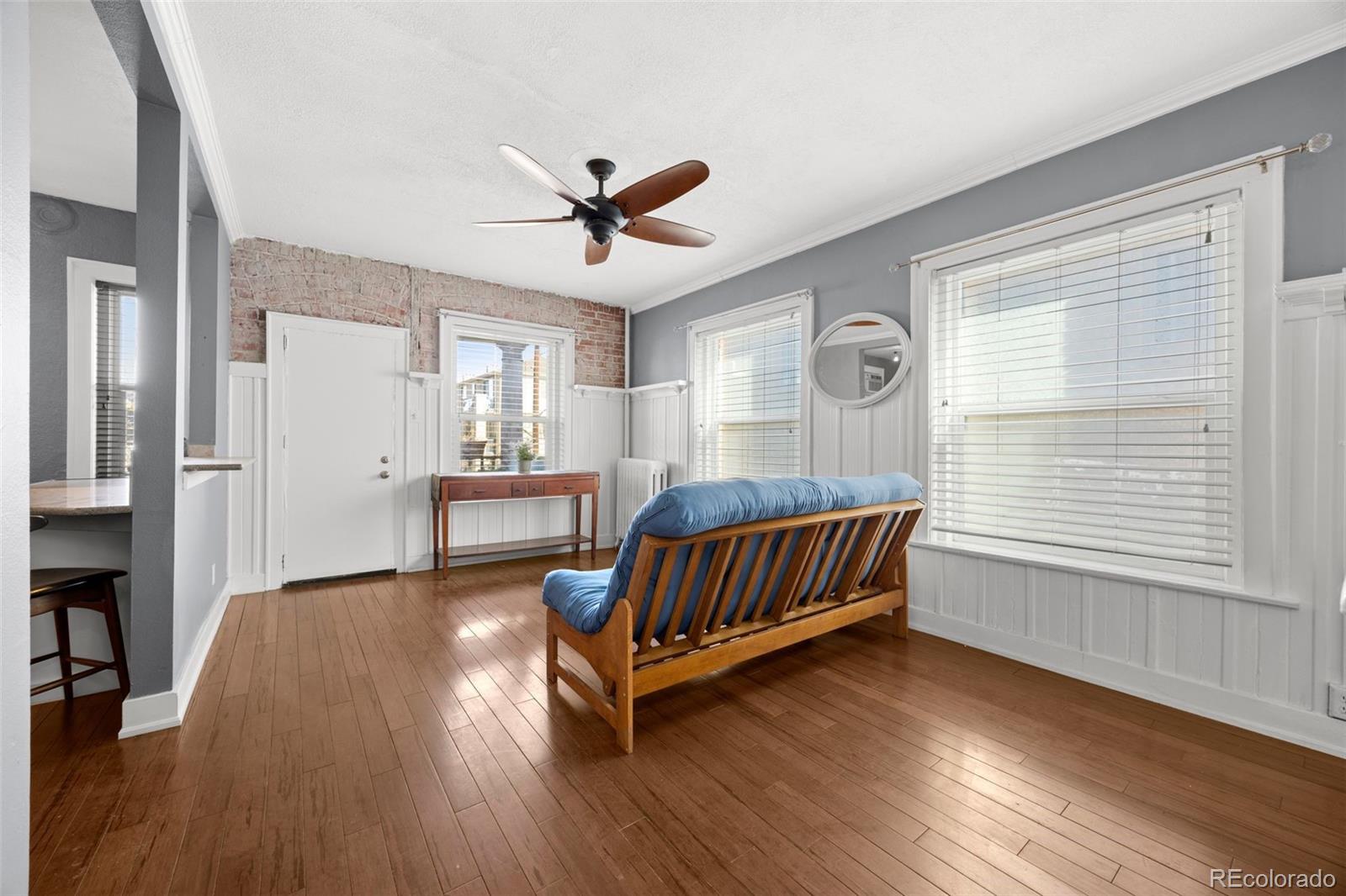 1376 Pearl Street, Unit 211 Denver, CO 80203 - Photo 10 of 26 a living room with wooden floor furniture and a window