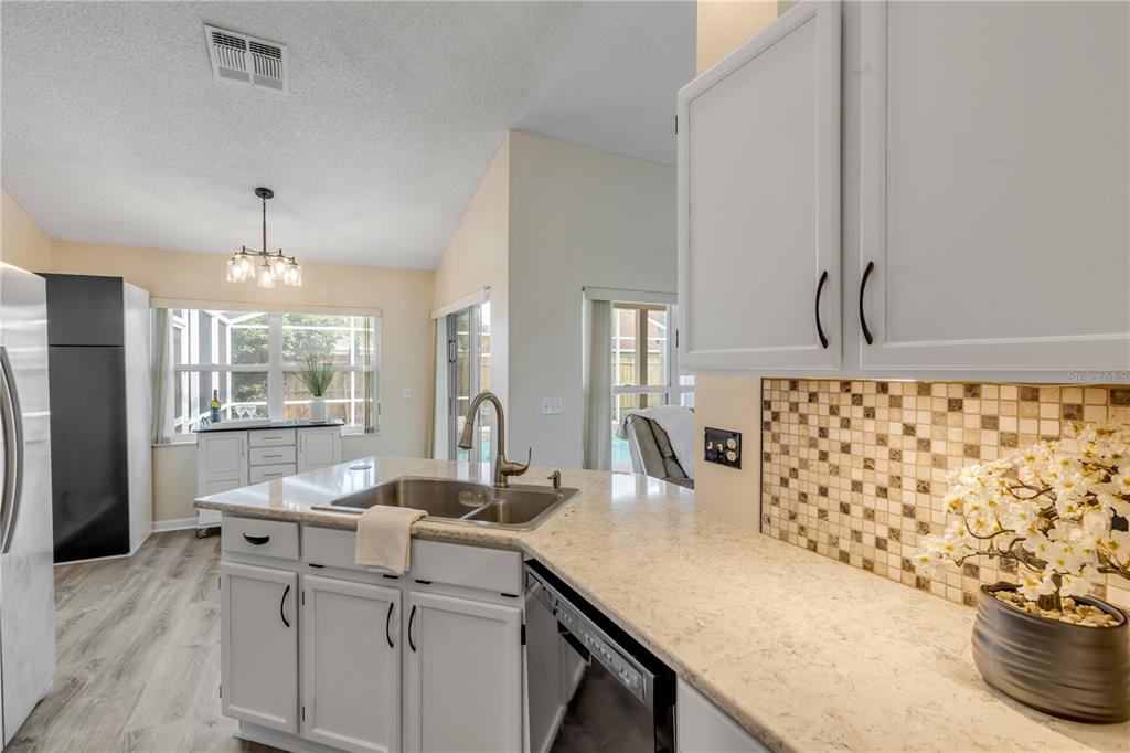 12232 Bronson Way Orlando, FL 32824 - Photo 11 of 32 a living room with a large window and chandelier