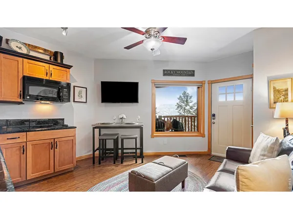 a kitchen with granite countertop a stove a sink and a dining table