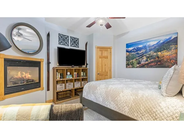 a living room with a bed and a painting on the wall