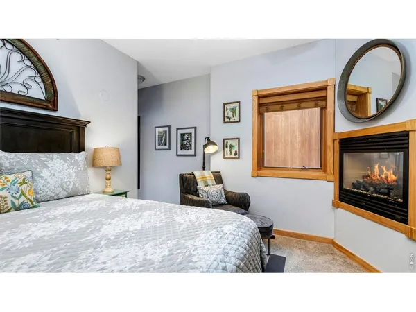 a living room with a bed furniture and a flat screen tv