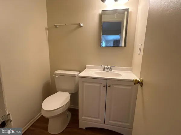 a white toilet sitting next to a bathroom sink